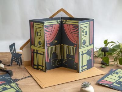 How to design a fold‑flat pop‑up theater that mails in an envelope and unfolds into a staged scene